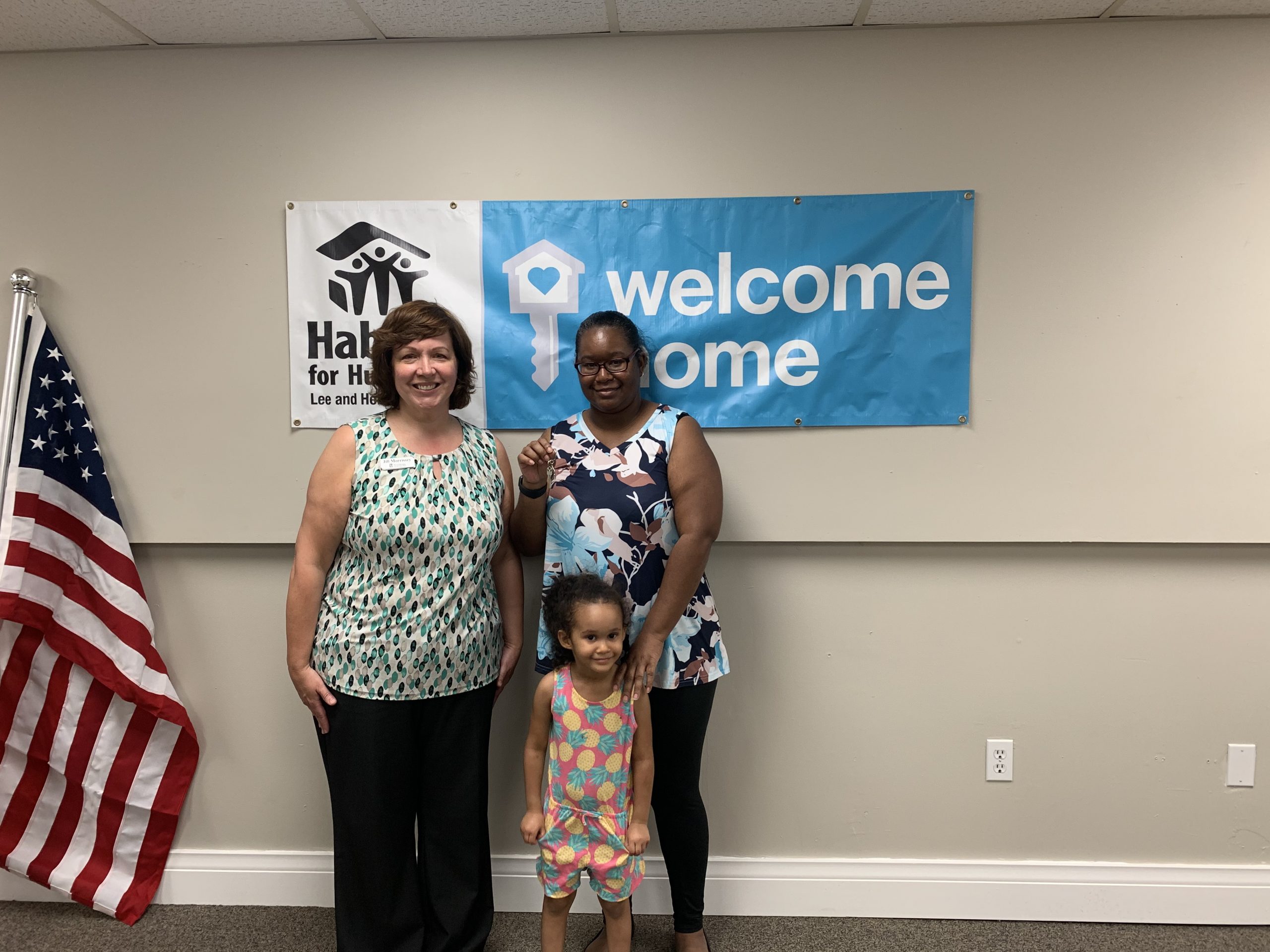 FineMark National Bank and Trust representative presents keys to new Habitat homeowner